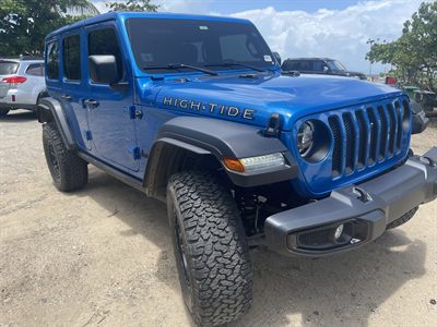 Front three-quarter view of the blue High Tide, showing the HIGH TIDE hood decal, flared arches and chunky all-terrain tires
