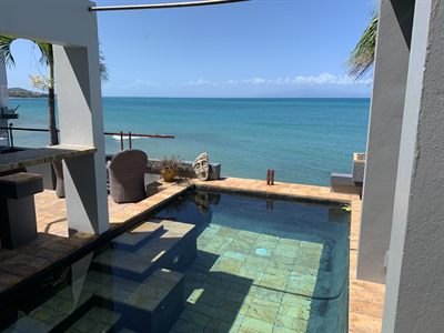 Cocktail pool set into the terrace with the ocean directly behind it