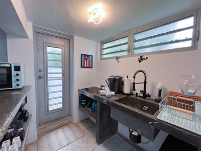 Kitchenette with a toaster oven, coffee maker and a glazed door to the outside