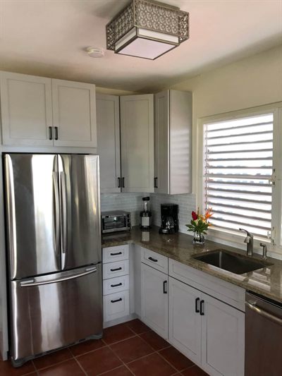 Chef's kitchen with granite counters, stainless fridge, dishwasher and a window over the sink
